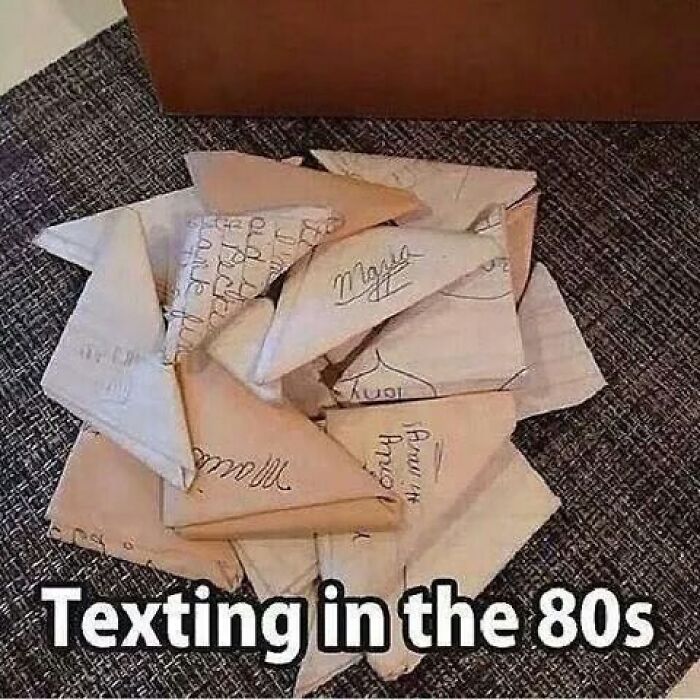 A pile of folded paper notes, representing 80s texting for Gen X memes and memory unlocking.