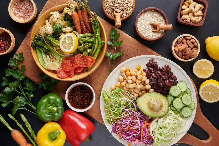 An overhead view of healthy food bowls, nuts, and vegetables, representing common things that are far worse than we realize.