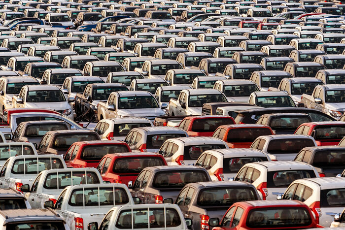 A vast parking lot filled with many new cars, representing common things that may turn out to be worse than we realize.