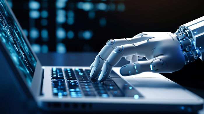 A robotic hand typing on a laptop, symbolizing common things that may turn out to be worse than we realize.