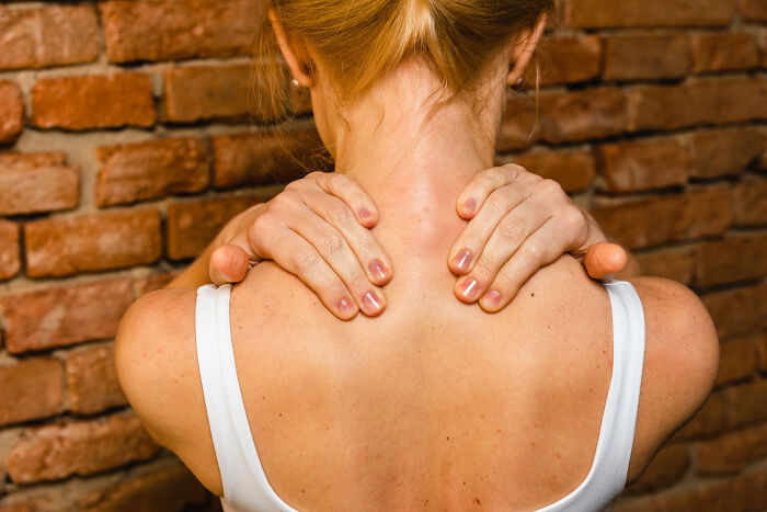 A woman massaging her neck and shoulders, indicating common things that may be worse than we realize.