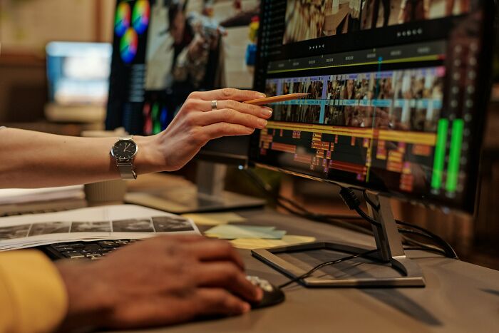 A person editing video on a computer, demonstrating how strange jobs can involve media production.