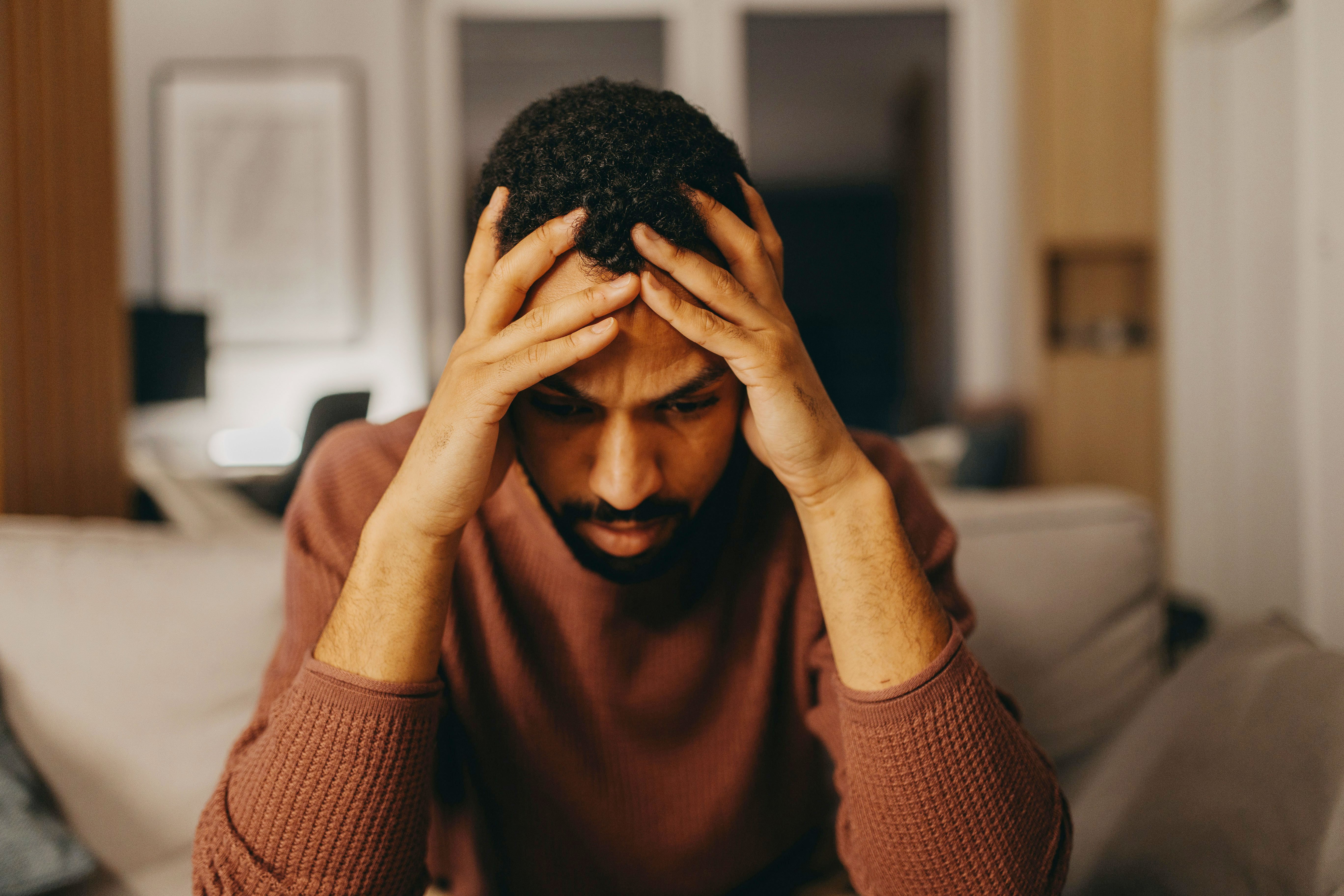 A man with his head in his hands, looking distraught after an Old Karen tried to kidnap his own stepson. A man with his head in his hands, looking distraught after an Old Karen tried to kidnap his own stepson.