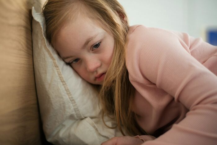 A young girl in a pink shirt looks sad, illustrating a babysitting story that might make your heart skip a beat.