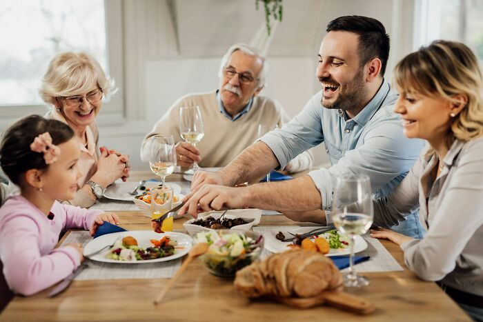 A family enjoying a meal together, highlighting potential culture shocks between international partners.