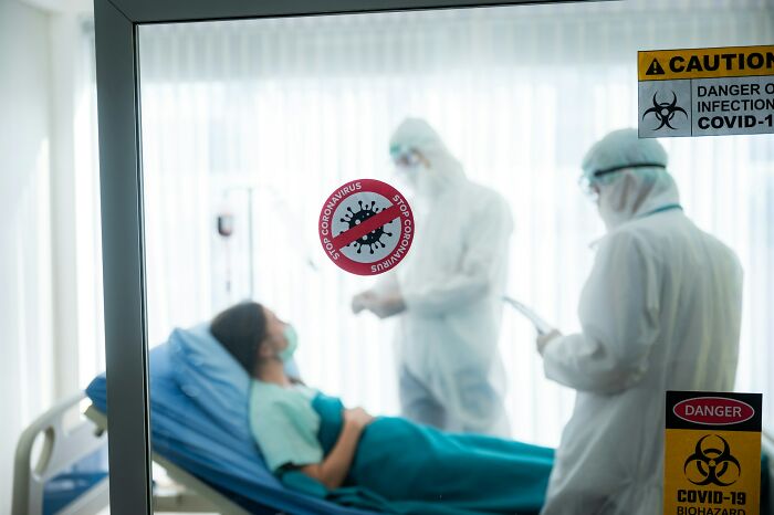 Medical staff in PPE treating a patient, illustrating how intuition can guide preparedness in healthcare scenarios.