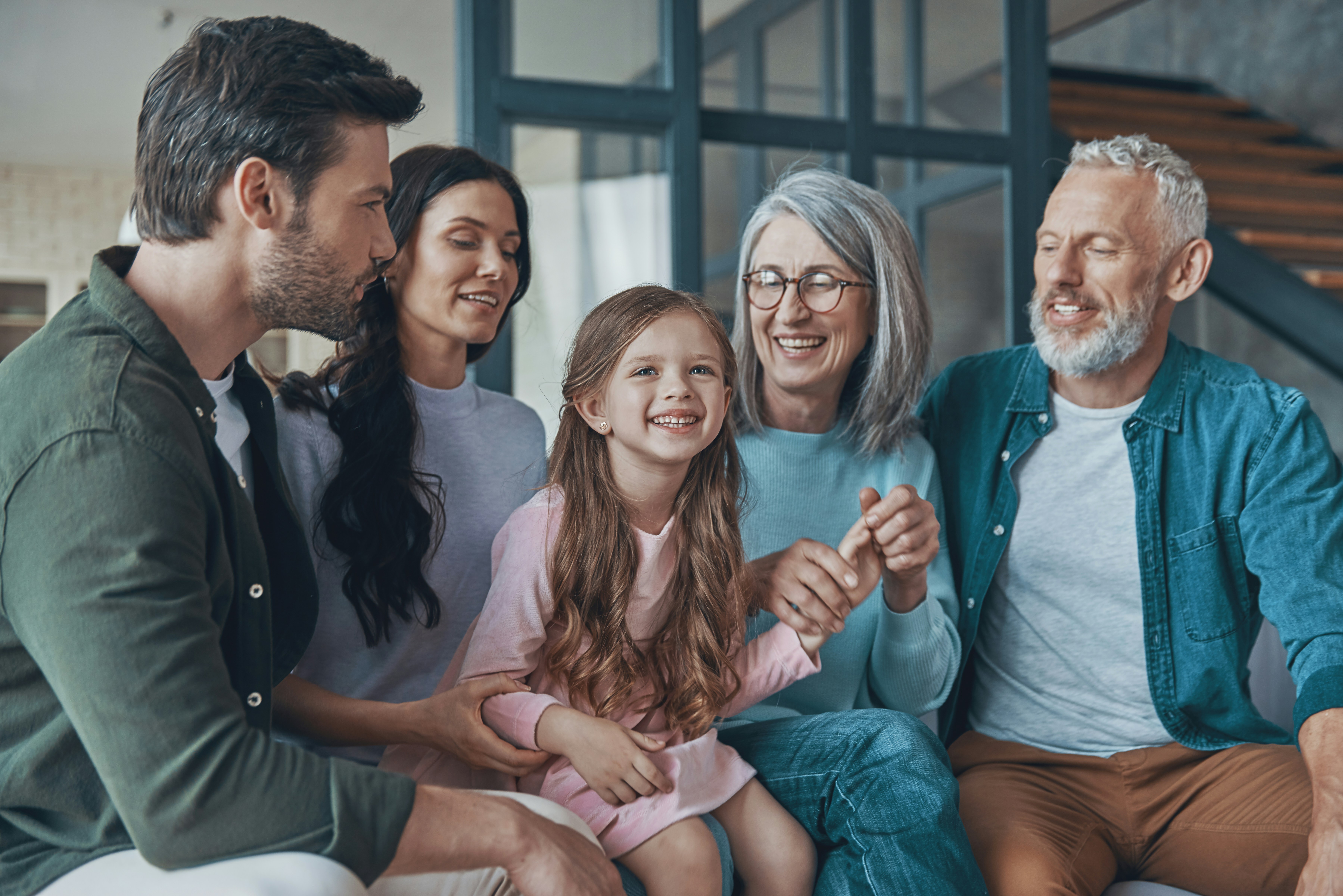 A happy multigenerational family, including a couple, child, and older parents, in their dream home. A happy multigenerational family, including a couple, child, and older parents, in their dream home.