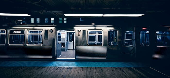 A dark subway station with an empty train car, an unsettling public experience that was scary.