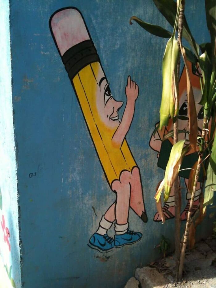 A cartoon pencil with a smiling face and sneakers on a wall, depicting a design failure.