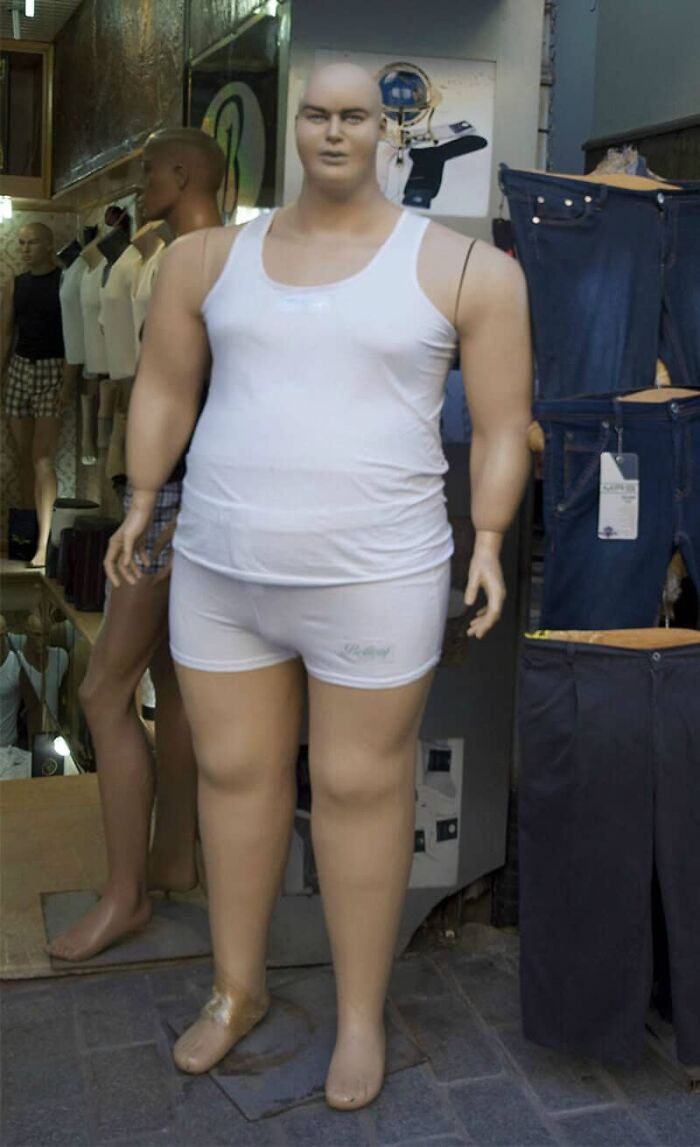 A poorly designed mannequin, appearing disproportionate and ill-fitting, showcasing a designer's failure.
