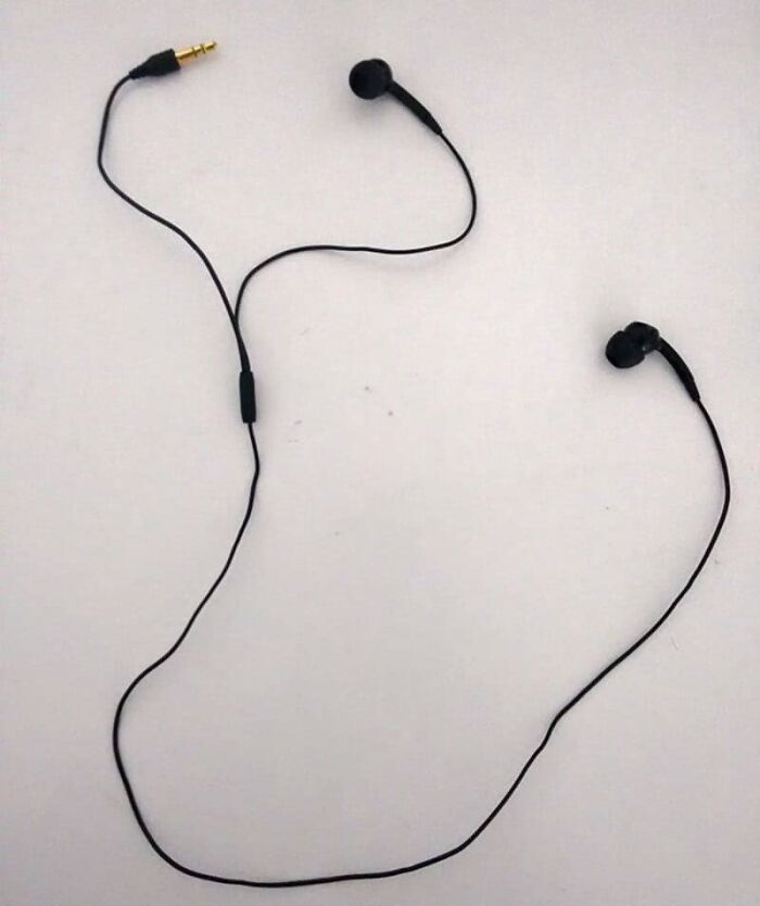 A pair of black earphones with one earbud having a very long cord and the other a short one, a design job failed dismally.