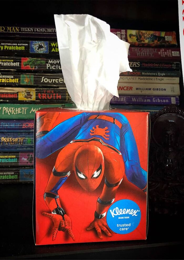 A box of Kleenex tissues featuring Spider-Man, with a tissue pulled out. A humorous design fail by designers.