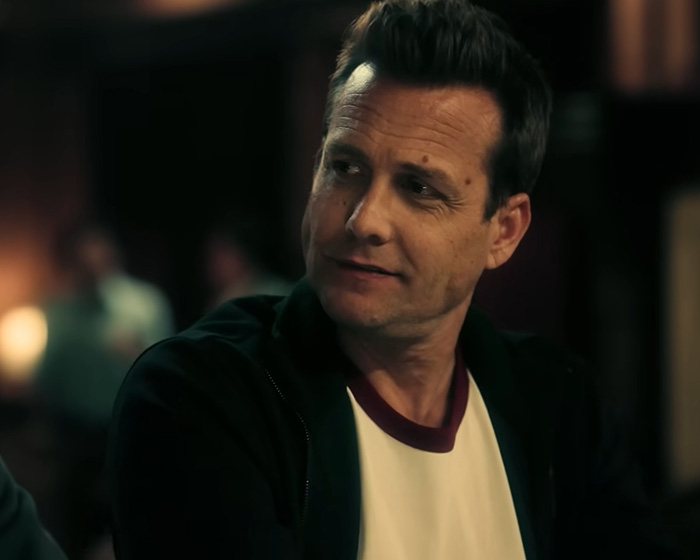 A close-up of a Hollywood star looking off to the side, wearing a white and red shirt with a dark jacket. A close-up of a Hollywood star looking off to the side, wearing a white and red shirt with a dark jacket.