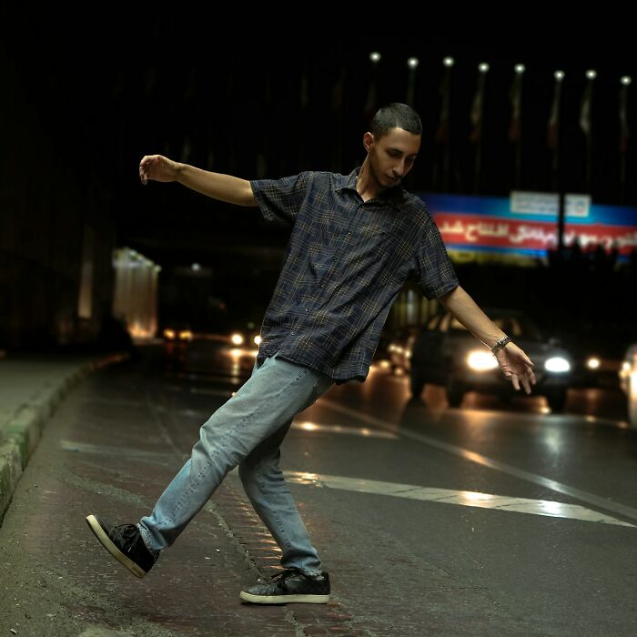 A man standing in a street at night, a disturbing public encounter.
