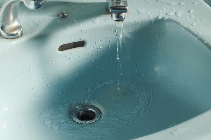 Water running into a sink, a scene from hospital employees' horror stories. The eerie atmosphere adds to the mystery.