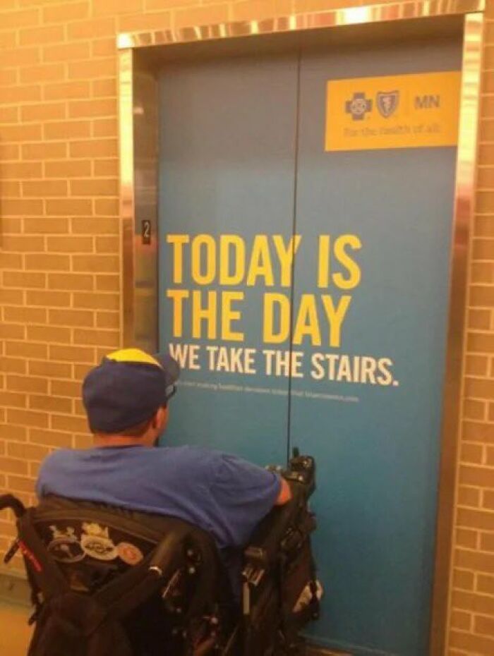 A person in a wheelchair faces an elevator door with a sign that reads 'TODAY IS THE DAY WE TAKE THE STAIRS,' an ironic scene turned into entertaining memes for X.