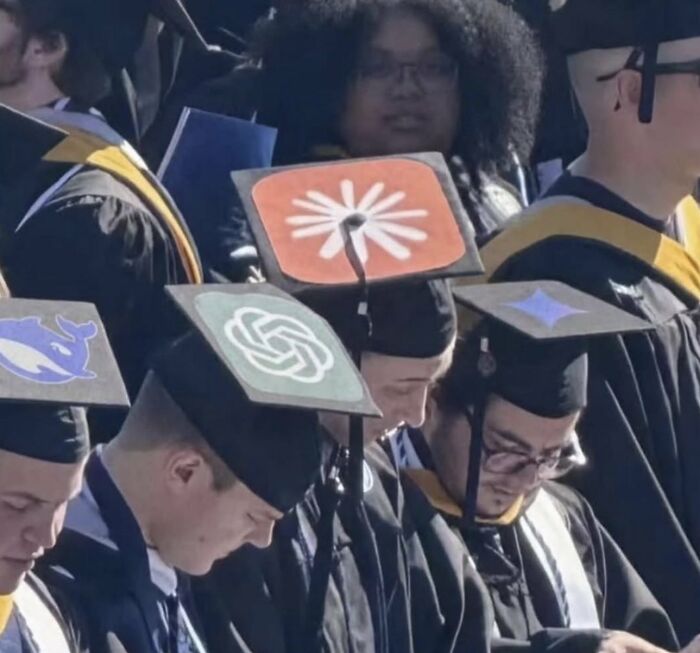 A group of graduates in caps and gowns, with decorated graduation caps featuring logos like GitHub Copilot, OpenAI, and Docker.