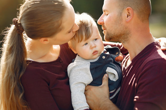 A pregnant wife and husband with their baby, illustrating a guy who cheats on his pregnant wife. A pregnant wife and husband with their baby, illustrating a guy who cheats on his pregnant wife.