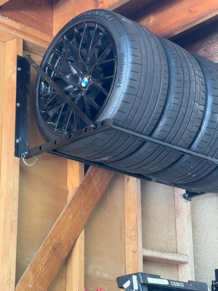 A wall-mounted tire rack in a garage, a practical and creative home DIY project for storage.