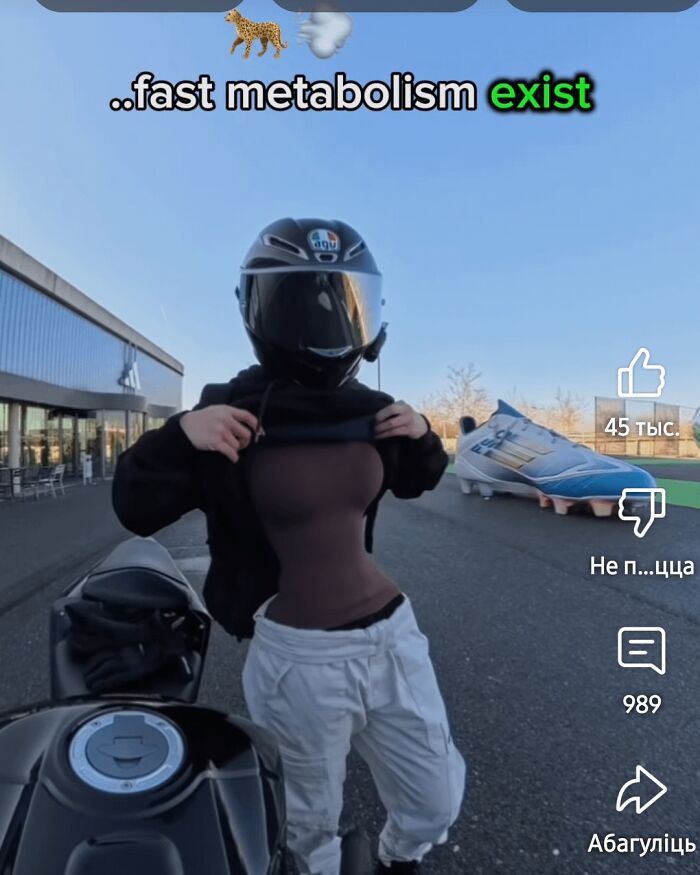 A person with a thin waist wearing a motorcycle helmet and undershirt, demonstrating fast metabolism.