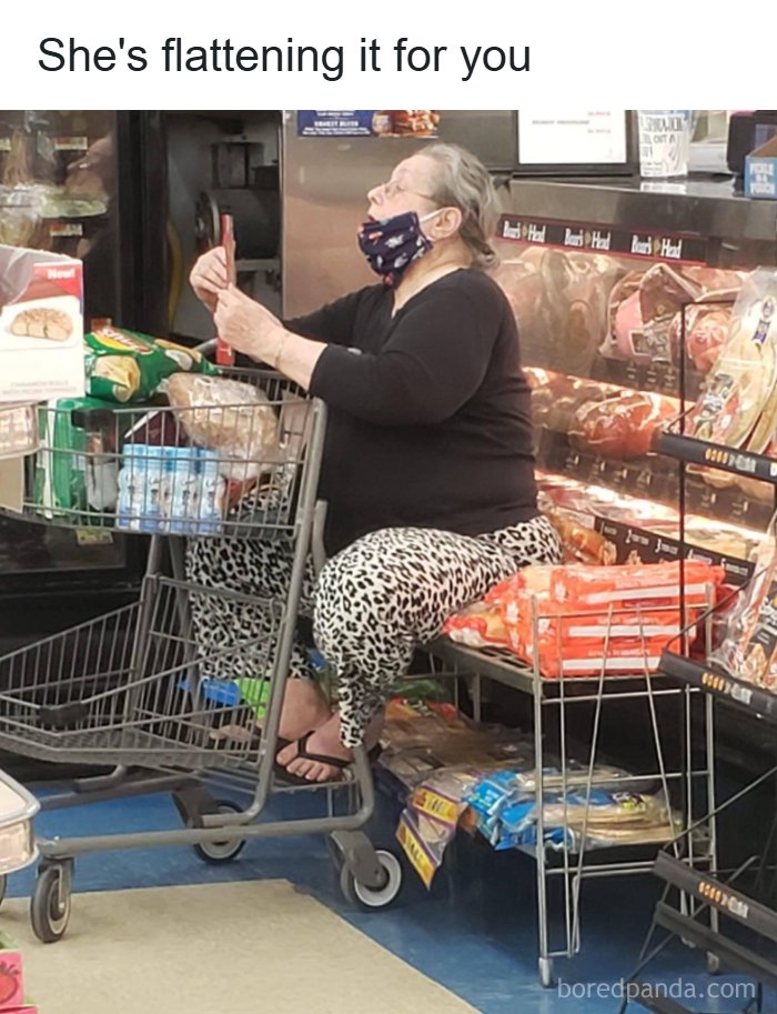 A woman sitting on a shopping cart and merchandise, showing cultural decline into idiocy.