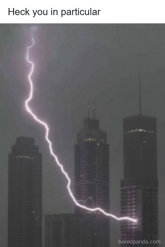 Hilarious memes and roasts: A dramatic lightning bolt striking between two tall city buildings on a gloomy day.