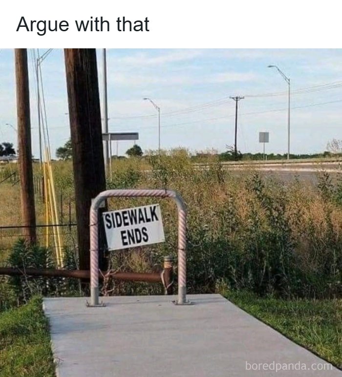 A sign on a short pole in a rural area that reads 'SIDEWALK ENDS', an image showing America's cultural decline into idiocy.
