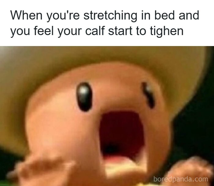 Hilarious meme of a shocked cartoon character reacting to a relatable calf muscle cramp while stretching in bed.