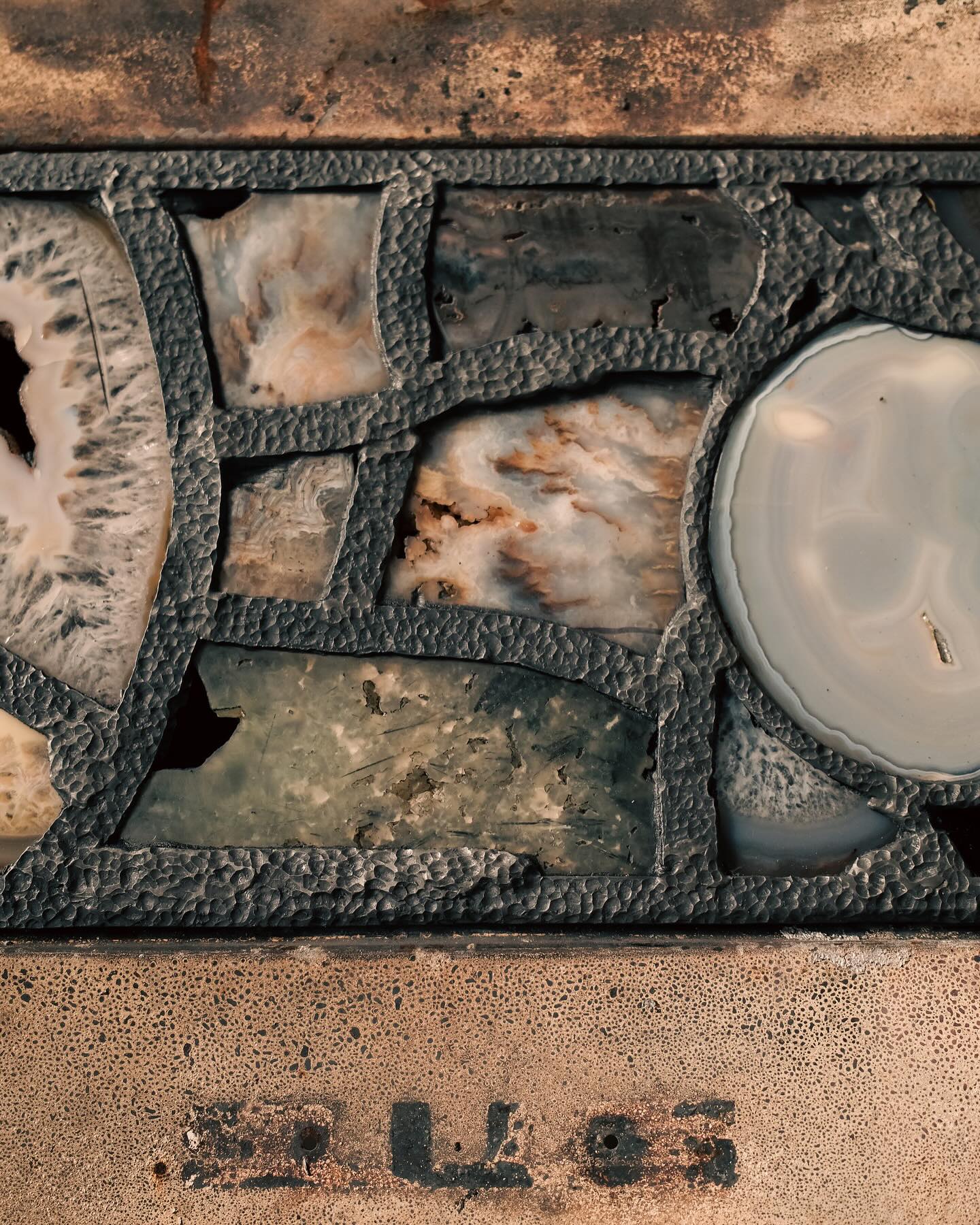 Detail of the extraordinary stained-glass sculpture crafted from a burned and rusted Porsche 911.