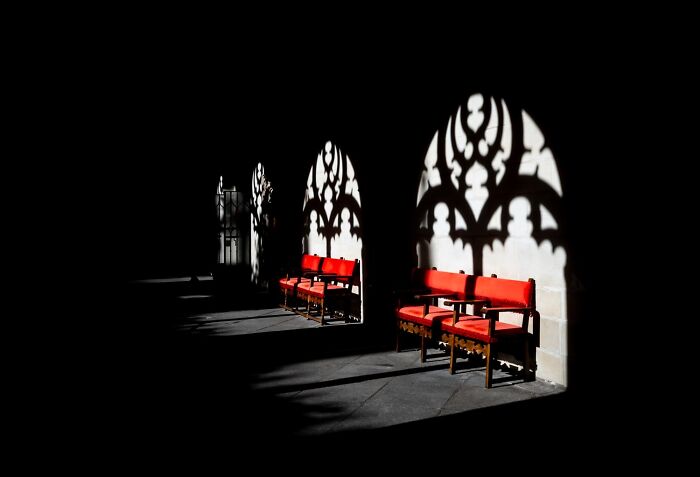 Striking color photos from reFocus contest, featuring ornate shadows cast by windows on red benches.