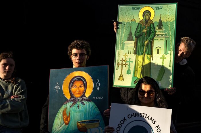 A photographer captures humor and chaos with people holding religious icons in everyday life.
