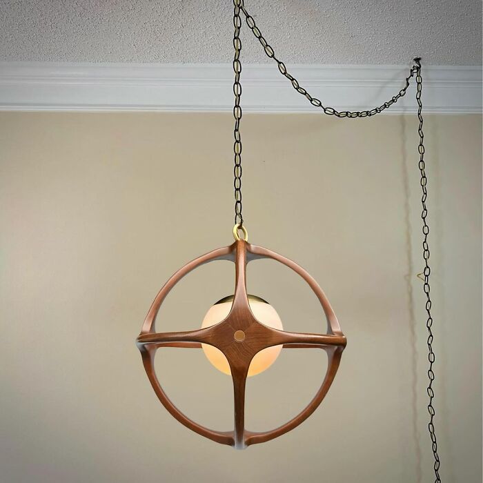 A unique wooden chandelier with a globe bulb, showcasing brilliant design choices.