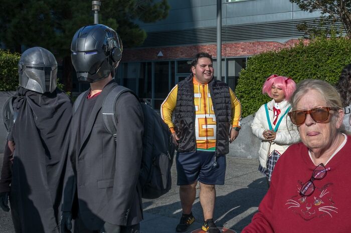 A photographer captures humor and chaos of people in costumes and an older woman in everyday life.