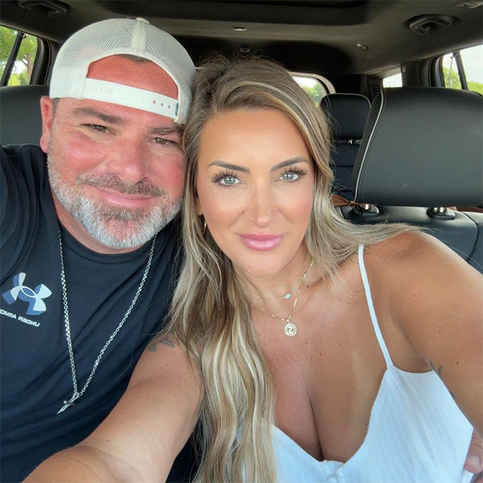 An influencer smiling with her husband in a car, capturing a moment from their life before the tragic event.
