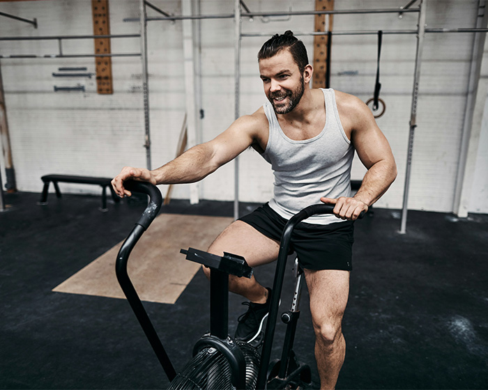 Influencer working out on an exercise bike, gaining attention for a sickening detail.