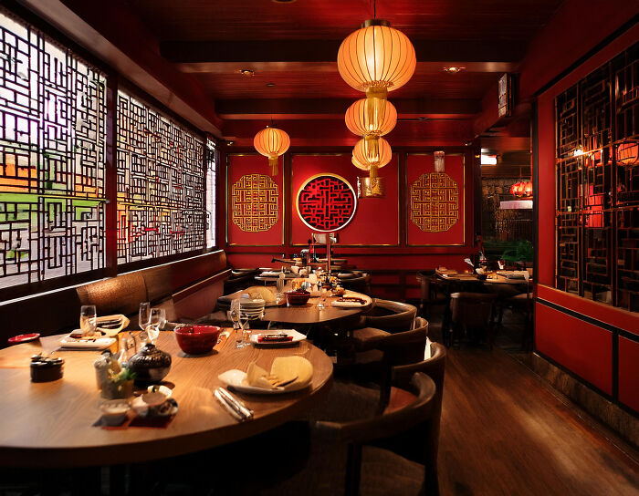 An empty Chinese restaurant with red decor and lanterns, providing a place to reflect on World War II veterans' stories.