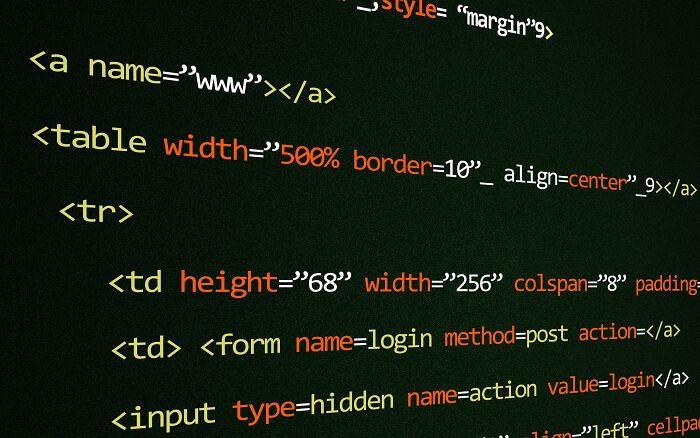 A close-up of computer code on a dark screen, showing lines of HTML with various tags and attributes, representing internet rabbit holes.