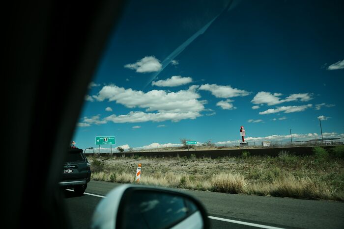 A view from inside a car on a highway, showing disturbing public sights.