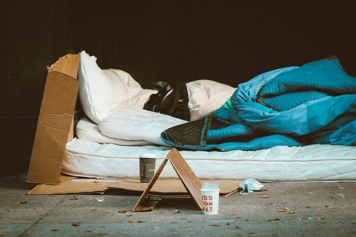 A makeshift bed on the street, illustrating disturbing public scenes.