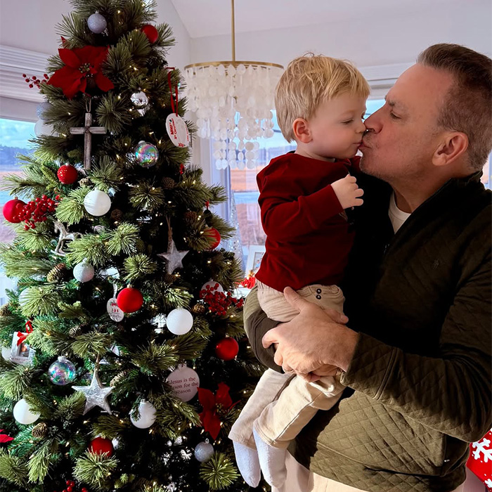 Karoline Leavitt's husband and child with a festive Christmas tree, highlighting their family life amidst age gap controversy.