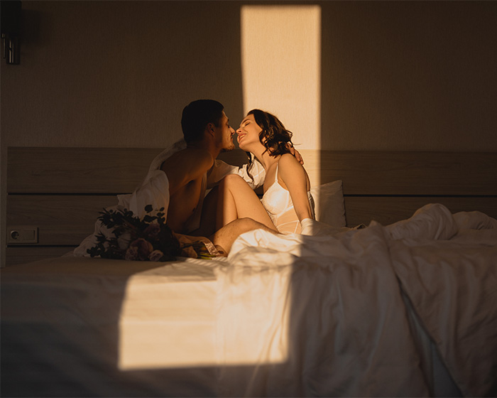 A couple sharing an intimate moment in bed, symbolizing the topic of libido confession and debate.