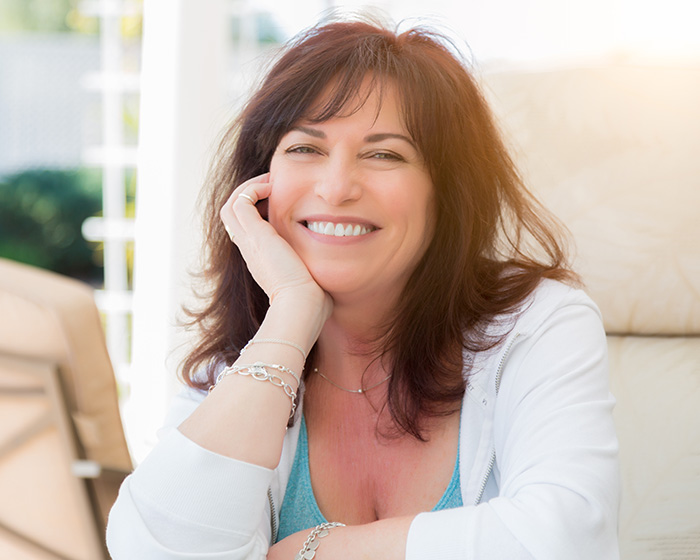 A smiling woman, possibly a doctor weighing in on the Kate Hudson libido confession debate.
