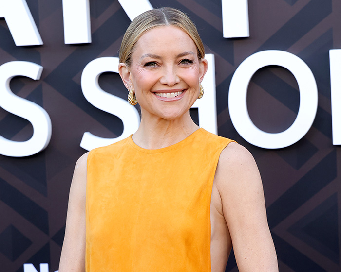Kate Hudson smiling on the red carpet, sparking a debate about her libido confession.