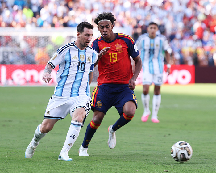 World Cup hero Lionel Messi in action during a football match, displaying his skill to female fans. World Cup hero Lionel Messi in action during a football match, displaying his skill to female fans.