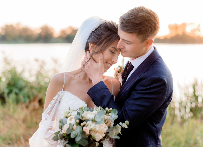 A newlywed couple embraces, reflecting on a man who cheats on GF and has another baby. A newlywed couple embraces, reflecting on a man who cheats on GF and has another baby.