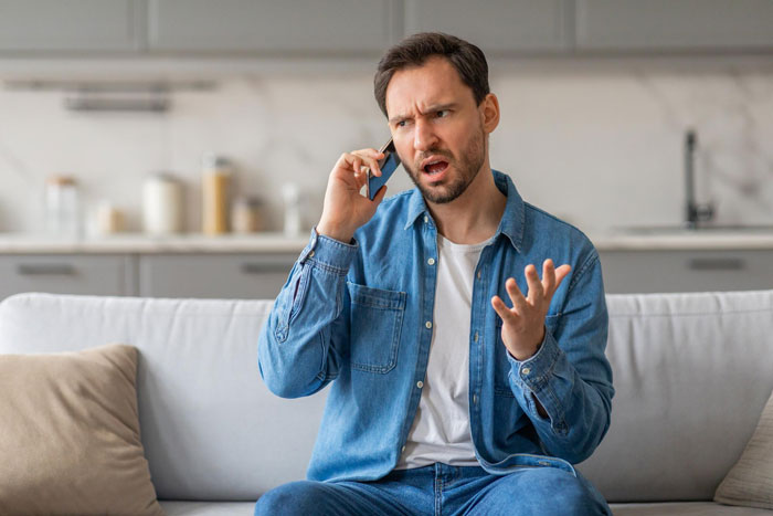 A man looks angry on the phone, upset his GF is dating his childhood friend after he cheated and had another baby. A man looks angry on the phone, upset his GF is dating his childhood friend after he cheated and had another baby.