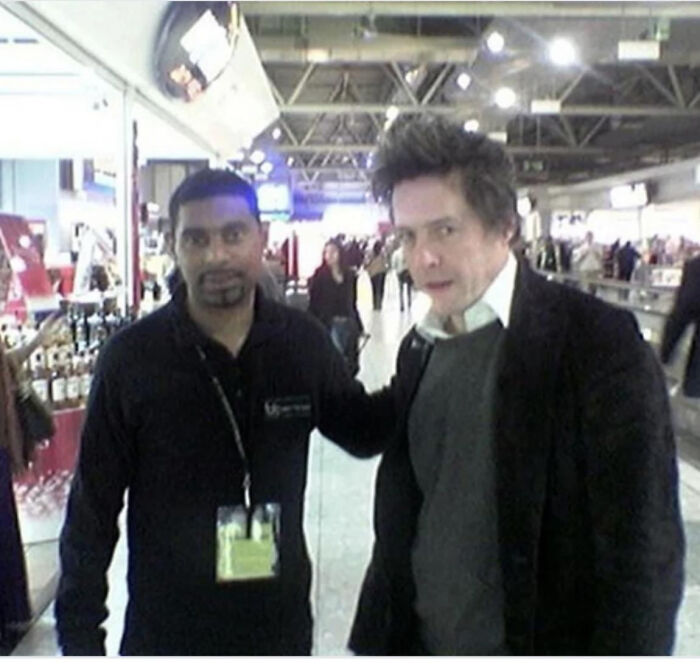 Two men, one with a hand on the other's shoulder, in an indoor setting, reflecting a moment someone asked a celebrity for a photo.