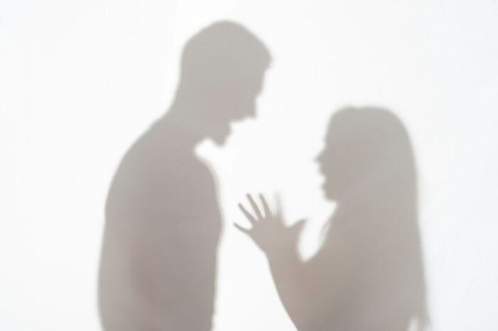Silhouettes of a couple arguing, depicting the harsh realities of being married.