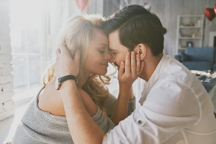 A loving couple embracing with eyes closed, highlighting the intimate moments of being married.