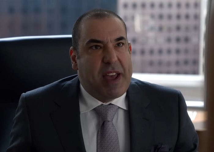 A major Hollywood star with an unrecognizable look, dressed in a suit, speaking intensely. A major Hollywood star with an unrecognizable look, dressed in a suit, speaking intensely.